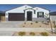 Charming single-story home with a well-manicured, low-maintenance front yard at 20328 N 225Th Dr, Surprise, AZ 85387