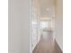 Inviting hallway with wood-style tile flooring leading to a bright, open kitchen at 20931 E Via Del Sol St, Queen Creek, AZ 85142