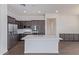 This kitchen features a large island, stainless appliances and dark wood cabinets at 20931 E Via Del Sol St, Queen Creek, AZ 85142