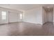 Spacious living room showcasing wood-style tile flooring and ample natural light at 20931 E Via Del Sol St, Queen Creek, AZ 85142