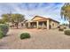 Desert landscaped backyard featuring a covered patio and outdoor seating at 2477 E Valencia Dr, Casa Grande, AZ 85194