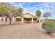 View of the backyard featuring desert landscaping, covered patio and outdoor seating at 2477 E Valencia Dr, Casa Grande, AZ 85194