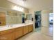 Bathroom featuring double sinks, a large mirror, and access to a walk-in closet at 2477 E Valencia Dr, Casa Grande, AZ 85194