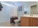 Clean bathroom with a shower, toilet, and vanity with a mirror at 2477 E Valencia Dr, Casa Grande, AZ 85194