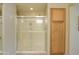 Bathroom featuring a glass shower and wooden storage cabinet at 2477 E Valencia Dr, Casa Grande, AZ 85194