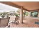 Inviting covered patio with brick flooring, lounge chairs, and views of the desert landscape at 2477 E Valencia Dr, Casa Grande, AZ 85194