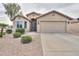 Inviting single-story home featuring desert landscaping and a two-car garage at 2477 E Valencia Dr, Casa Grande, AZ 85194