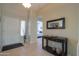 Well-lit foyer with tile flooring, a console table, and a view into the hallway at 2477 E Valencia Dr, Casa Grande, AZ 85194