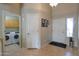 Functional foyer with laundry access and a view of the front door at 2477 E Valencia Dr, Casa Grande, AZ 85194