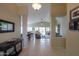 Open foyer leading to the living room with a view of the kitchen and backyard at 2477 E Valencia Dr, Casa Grande, AZ 85194