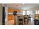 Well-lit kitchen with a breakfast bar, modern appliances, wood cabinetry, and tile flooring at 2477 E Valencia Dr, Casa Grande, AZ 85194