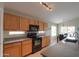 The kitchen features ample counter space, wood cabinets, and modern black appliances at 2477 E Valencia Dr, Casa Grande, AZ 85194