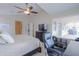 Bright main bedroom featuring a ceiling fan, ample natural light, and a cozy area for a desk at 2477 E Valencia Dr, Casa Grande, AZ 85194