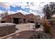 Large backyard featuring a stone patio, dining set, hot tub, grill, and covered patio for entertaining guests at 24816 N Good Pasture Ln, Florence, AZ 85132