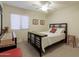 Bedroom featuring carpet, ceiling fan and a dark wood bed frame at 24816 N Good Pasture Ln, Florence, AZ 85132