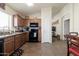 Bright kitchen with wooden cabinets, tile floor, and modern black appliances at 24816 N Good Pasture Ln, Florence, AZ 85132