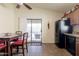 Kitchen featuring a table with red chairs, black appliances, and sliding glass door at 24816 N Good Pasture Ln, Florence, AZ 85132