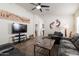 Inviting living room with comfortable seating, a ceiling fan, and artwork enhancing the cozy atmosphere at 24816 N Good Pasture Ln, Florence, AZ 85132