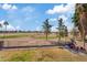 Backyard view with grass, trees, patio, and view of a golf course in the distance at 2535 E Saratoga St, Gilbert, AZ 85296