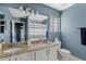 Well-lit bathroom featuring double sinks, a granite countertop, and modern fixtures at 2535 E Saratoga St, Gilbert, AZ 85296