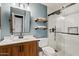 Bathroom with a wood vanity, vessel sink, framed mirror, and walk-in shower with glass door at 2535 E Saratoga St, Gilbert, AZ 85296