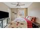 Cozy bedroom with a ceiling fan, window, TV, and comfortable looking patterned bedding at 2535 E Saratoga St, Gilbert, AZ 85296