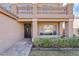 Covered front entrance featuring an decorative wrought iron door, manicured shrubs, and brick pavers at 2535 E Saratoga St, Gilbert, AZ 85296