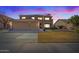 Two-story home with tile roof, balcony, three-car garage and manicured lawn at dusk at 2535 E Saratoga St, Gilbert, AZ 85296