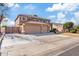 Two-story home with a three-car garage, tile roof and manicured lawn on a sunny day at 2535 E Saratoga St, Gilbert, AZ 85296