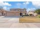 Two-story home with tile roof, balcony, three-car garage and manicured lawn on a sunny day at 2535 E Saratoga St, Gilbert, AZ 85296