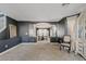 Spacious living room with neutral carpet, dark accent walls, columns, and views to the formal dining room at 2535 E Saratoga St, Gilbert, AZ 85296