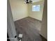 A bright bedroom featuring wood-look floors and a ceiling fan fixture at 2540 E Hartford Ave, Phoenix, AZ 85032