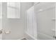 Bathroom featuring white tiled shower and tub with white curtain and window at 2622 E Monument Canyon Ave, Apache Junction, AZ 85119