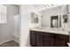 Bright bathroom featuring double sinks, granite counters and dark wood cabinets at 2622 E Monument Canyon Ave, Apache Junction, AZ 85119