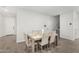 Dining area with a table, six chairs, a white vase, wood-look tile floors and neutral colors at 2622 E Monument Canyon Ave, Apache Junction, AZ 85119