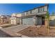 View of a two-story home featuring desert landscaping, gray exterior paint, and a gray garage door at 2622 E Monument Canyon Ave, Apache Junction, AZ 85119