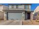 Two-story home with a gray exterior, gray garage door and a stacked stone accent on the columns at 2622 E Monument Canyon Ave, Apache Junction, AZ 85119