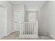 Upstairs hallway featuring white walls, white doors, carpet flooring, and a white railing at 2622 E Monument Canyon Ave, Apache Junction, AZ 85119