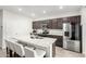 Kitchen featuring granite countertops, stainless steel appliances, dark cabinets, and an island with seating at 2622 E Monument Canyon Ave, Apache Junction, AZ 85119