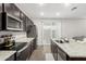 Kitchen with granite countertops, stainless steel appliances, dark cabinets, and wood-look tile flooring at 2622 E Monument Canyon Ave, Apache Junction, AZ 85119