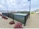 View of a community pickleball court surrounded by fencing and landscaping, adding a touch of greenery at 2622 E Monument Canyon Ave, Apache Junction, AZ 85119