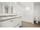 A bright bathroom featuring a double sink vanity, white shaker cabinets, a window, and a tiled shower at 2735 S 357Th Dr, Tonopah, AZ 85354