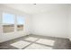 A bedroom with neutral carpeting, white walls, base trim, and a window with a view of the rural scenery at 2735 S 357Th Dr, Tonopah, AZ 85354