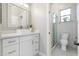 Bright bathroom featuring white cabinetry, quartz counters, and glass-enclosed shower at 27606 N 61St Pl, Scottsdale, AZ 85266