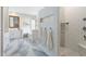 Bright bathroom featuring marble floors, bathtub, glass shower, and a vanity with sink at 27606 N 61St Pl, Scottsdale, AZ 85266