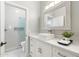 Modern bathroom featuring marble floors, vanity with sink, and a shower with glass door at 27606 N 61St Pl, Scottsdale, AZ 85266