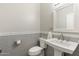 Stylish half bathroom featuring modern fixtures and gray tiling at 27606 N 61St Pl, Scottsdale, AZ 85266