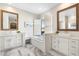 Bright bathroom featuring double sinks, marble floors, and bathtub with natural light at 27606 N 61St Pl, Scottsdale, AZ 85266