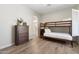 This bedroom features a bunk bed, wood floors, and a dresser with decorative plant at 27606 N 61St Pl, Scottsdale, AZ 85266