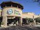 Exterior of a AJ's Fine Foods marketplace with a stone facade and manicured plants at 27606 N 61St Pl, Scottsdale, AZ 85266